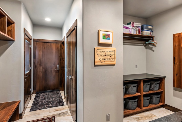 entryway featuring baseboards and marble finish floor