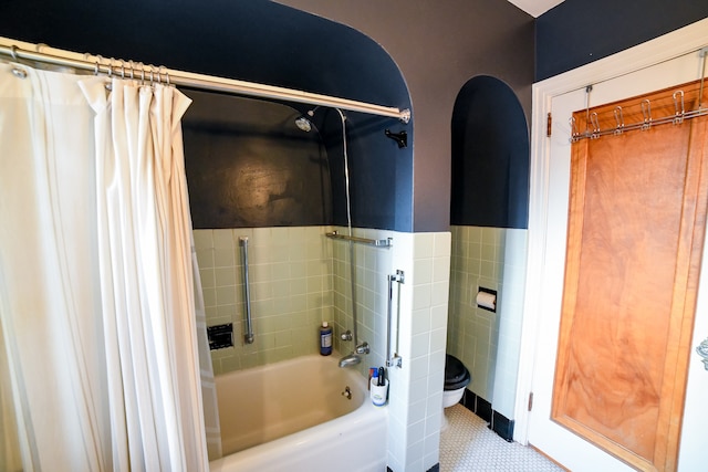 bathroom with tile patterned flooring, toilet, and shower / bath combo with shower curtain