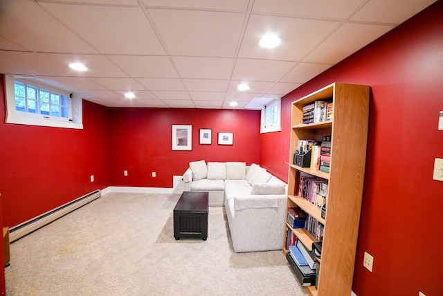 carpeted living room featuring baseboard heating, plenty of natural light, and a paneled ceiling