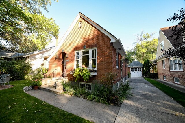 view of front of home with a front lawn, an outdoor structure, and a garage