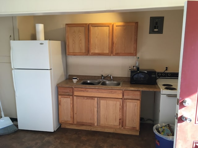 106 State St, Hamilton, MT 59840 - kitchen with white appliances, electric panel, and brown cabinetry
