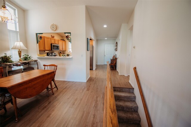 interior space with light hardwood / wood-style floors and a chandelier