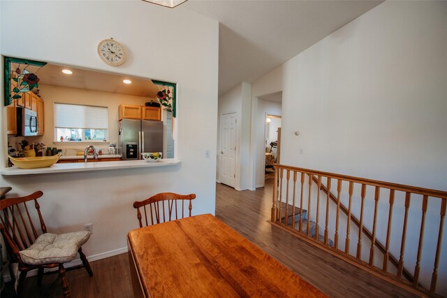 dining space featuring sink and dark hardwood / wood-style flooring