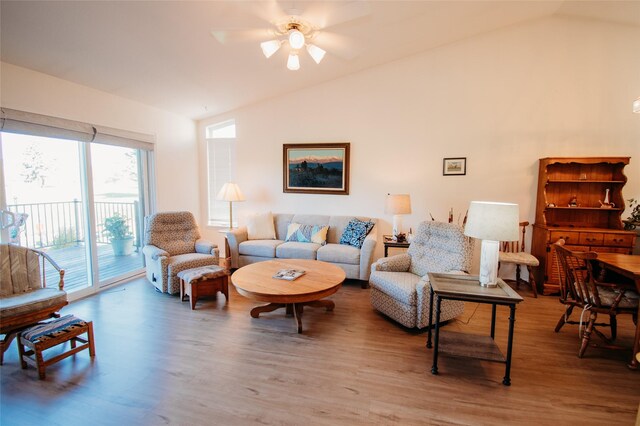 living room with lofted ceiling, ceiling fan, and hardwood / wood-style flooring