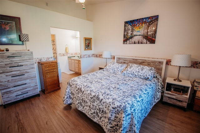 bedroom with sink, ensuite bathroom, and hardwood / wood-style flooring