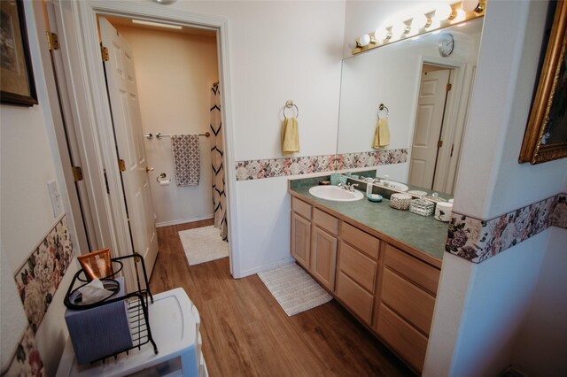 bathroom with hardwood / wood-style flooring and vanity