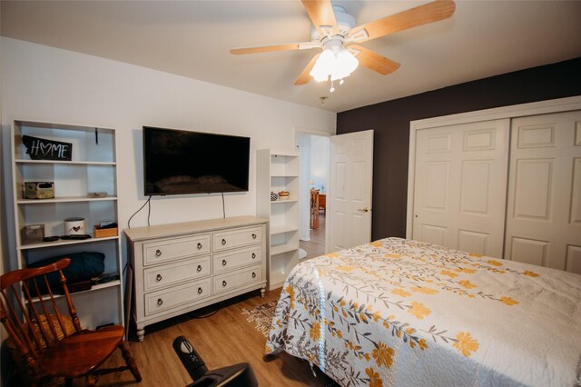 bedroom with ceiling fan, a closet, and hardwood / wood-style floors