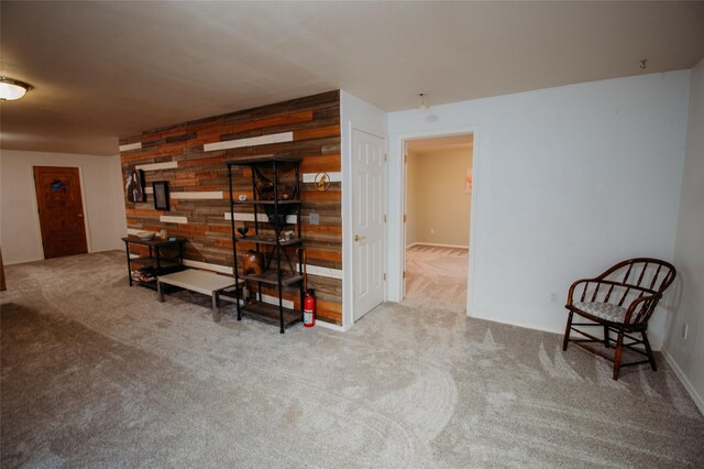 interior space featuring carpet flooring and wooden walls