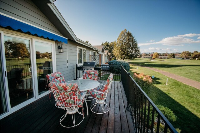 wooden deck featuring a yard