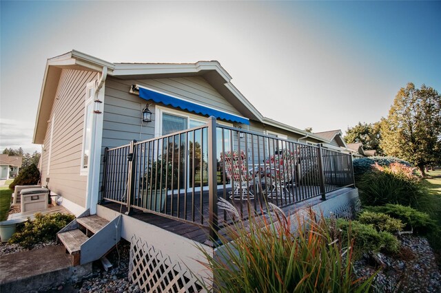 rear view of property featuring a deck