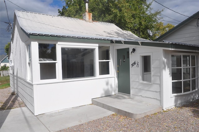 506/5061/2 W 3rd St, Polson, MT 59860 - doorway to property with a chimney and metal roof