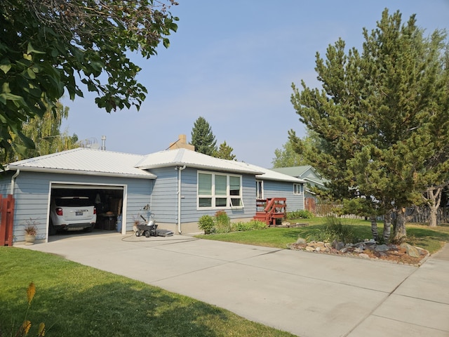 214 Laura St, Augusta, MT 59410 - ranch-style home featuring an attached garage, driveway, and a metal roof