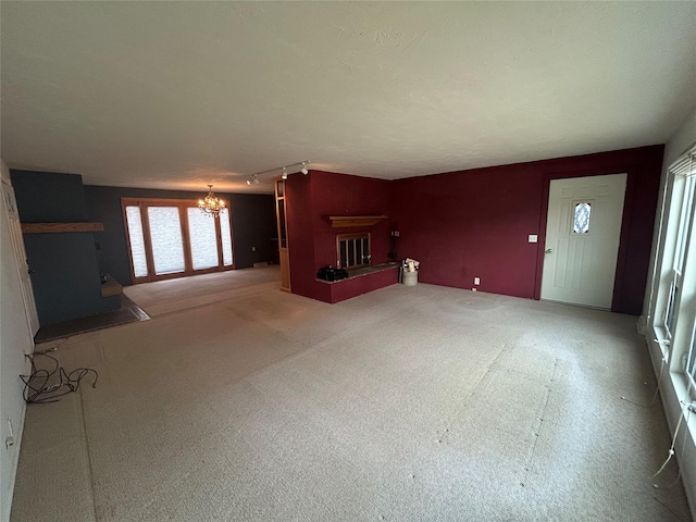 214 Laura St, Augusta, MT 59410 - unfurnished living room with a chandelier and a fireplace with raised hearth