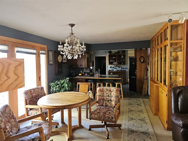 dining area featuring a notable chandelier