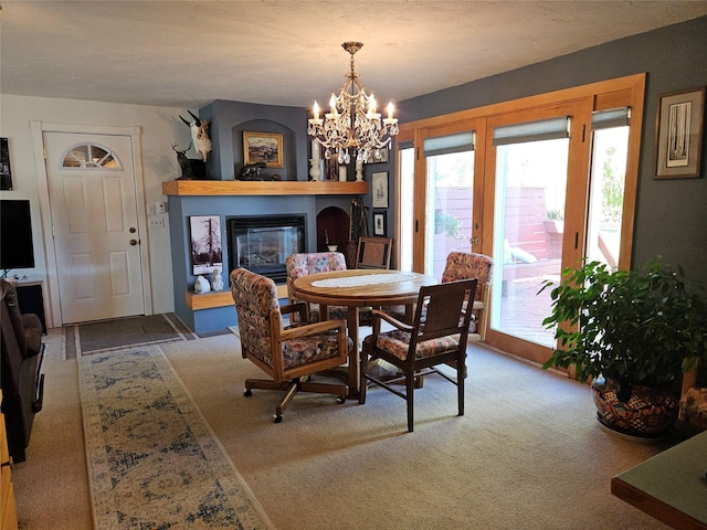 214 Laura St, Augusta, MT 59410 - dining area featuring a fireplace, a chandelier, and carpet floors