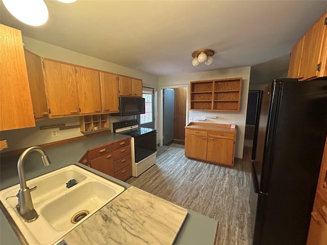 214 Laura St, Augusta, MT 59410 - kitchen with black appliances, open shelves, wood finished floors, and brown cabinets