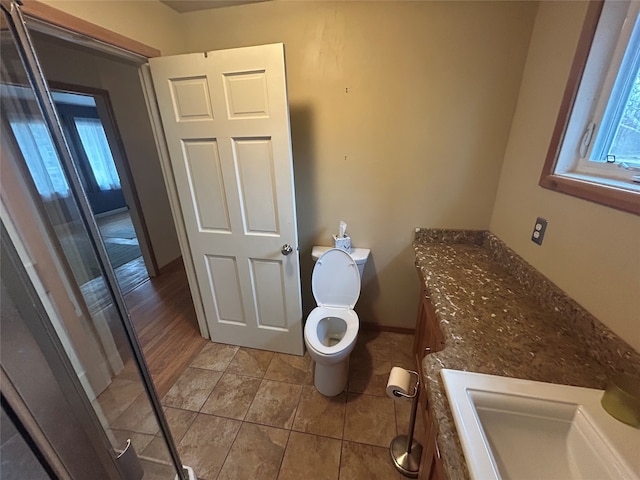 bathroom featuring hardwood / wood-style floors, toilet, and sink