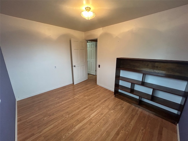 unfurnished bedroom with hardwood / wood-style floors