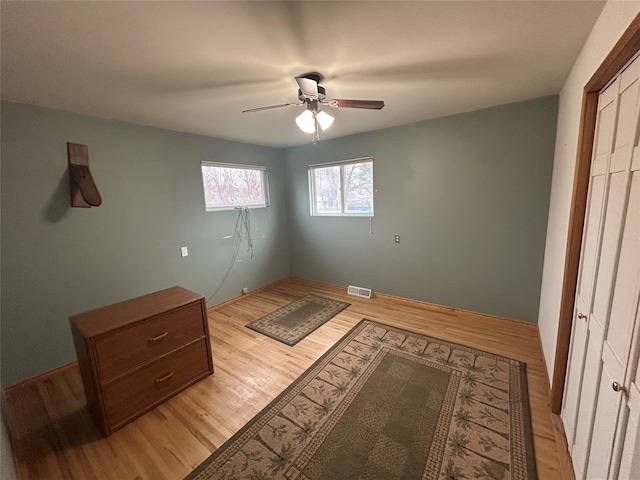 bedroom with ceiling fan and light wood-type flooring