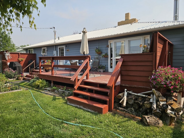 214 Laura St, Augusta, MT 59410 - back of property featuring a metal roof, a chimney, a wooden deck, and a yard