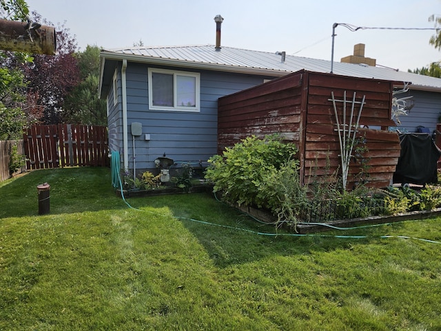 rear view of property with a lawn