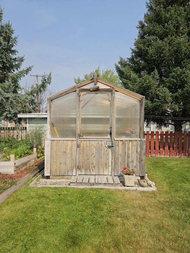 view of outbuilding with a lawn