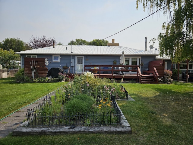 rear view of house featuring a yard and a wooden deck