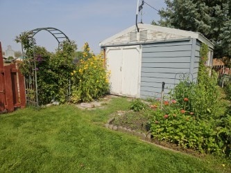 view of outbuilding featuring a lawn