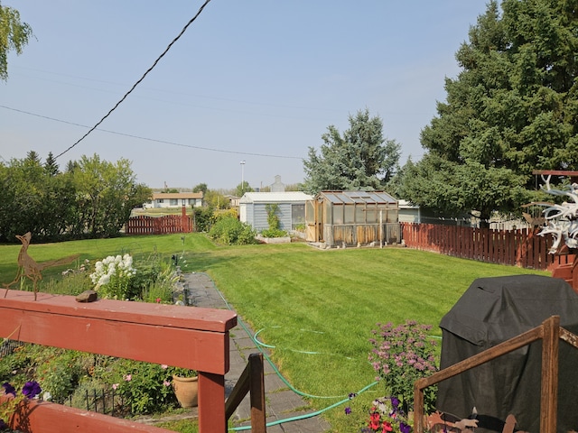 214 Laura St, Augusta, MT 59410 - fenced backyard featuring a greenhouse and an outbuilding