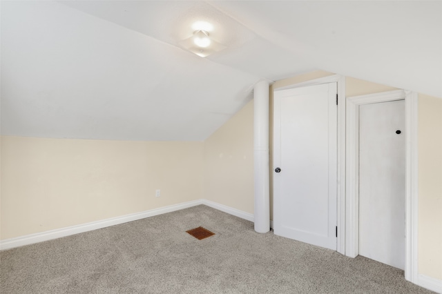 additional living space with lofted ceiling and carpet flooring