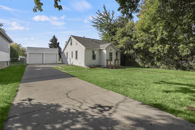 view of property exterior with a garage, a yard, and an outbuilding