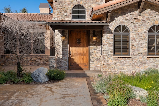 view of exterior entry with covered porch