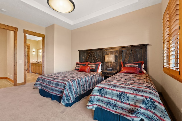 bedroom with carpet floors and ensuite bathroom