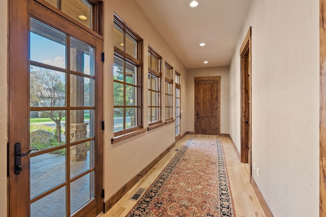 hall with light hardwood / wood-style flooring