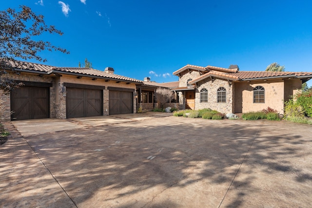 mediterranean / spanish-style house with a garage