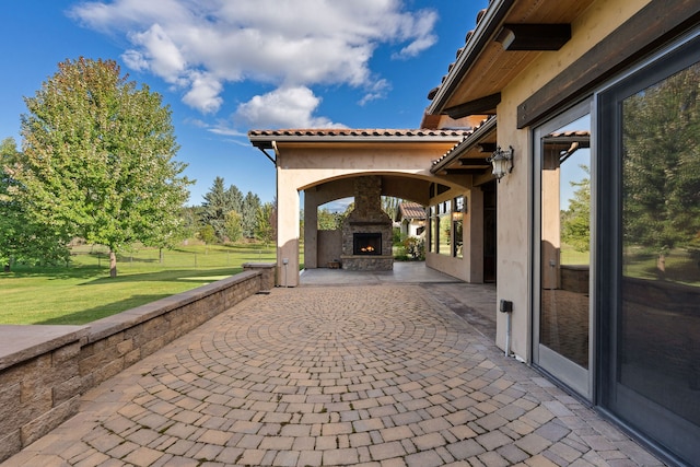 view of patio / terrace featuring an outdoor stone fireplace