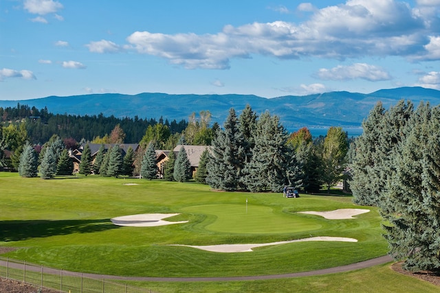 surrounding community featuring a yard and a mountain view