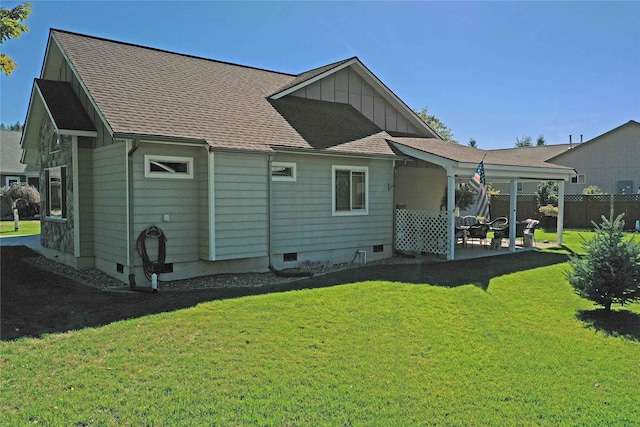 back of property featuring a lawn and a patio area