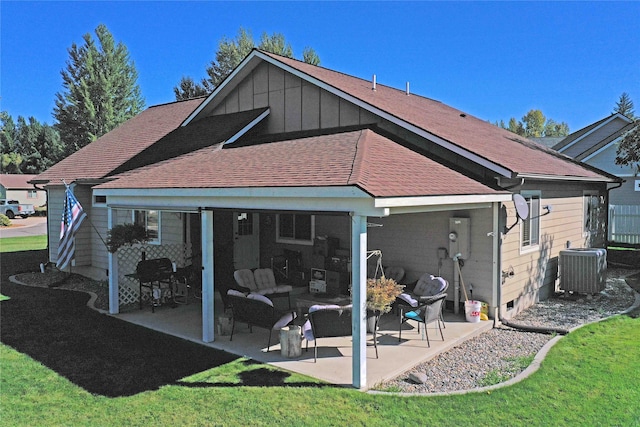 back of property featuring central AC unit, a lawn, and a patio area