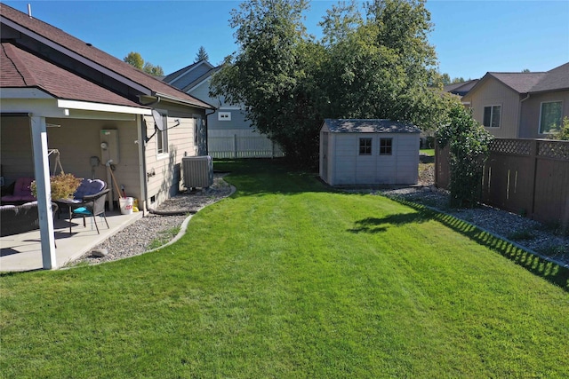 view of yard featuring cooling unit, a storage shed, and a patio area