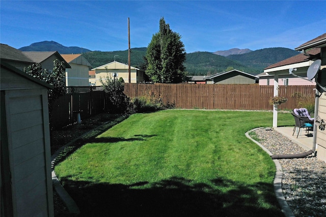 view of yard with a mountain view and a patio area