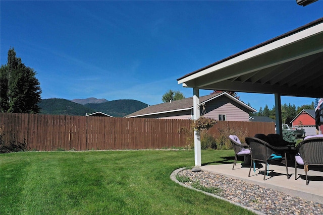 view of yard with a mountain view and a patio area