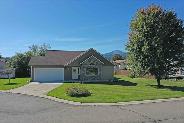 single story home featuring a mountain view, a garage, and a front lawn