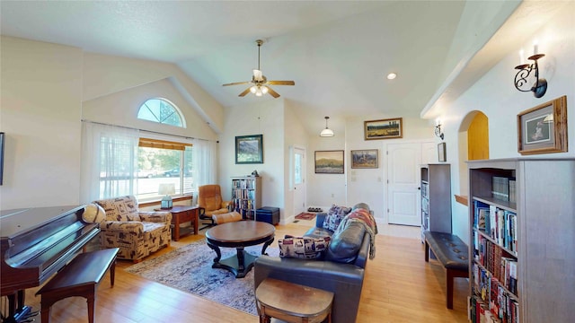 living room with high vaulted ceiling, light hardwood / wood-style floors, and ceiling fan