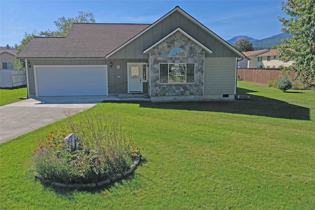 ranch-style home with a front yard and a garage