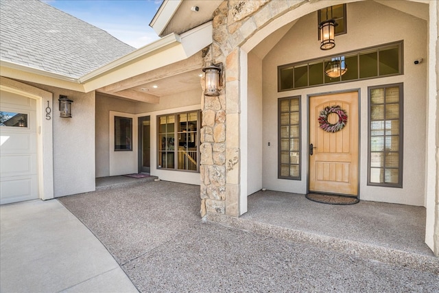 view of exterior entry with a garage