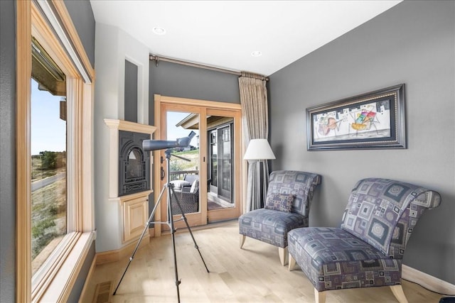 sitting room featuring visible vents, wood finished floors, and baseboards