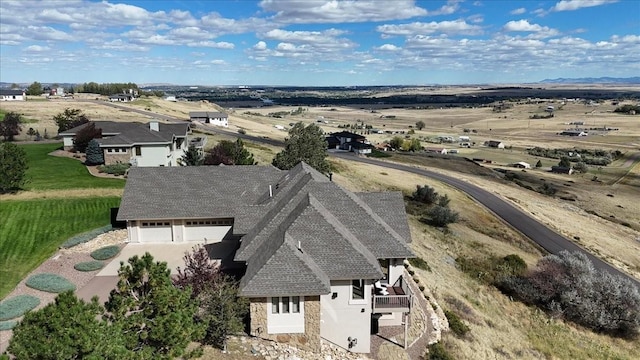 birds eye view of property with a rural view