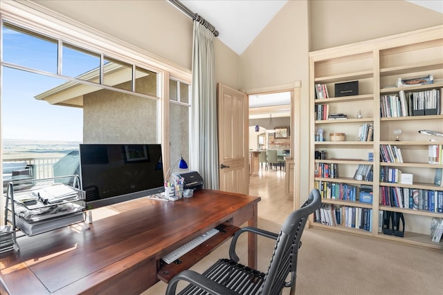 carpeted home office with lofted ceiling