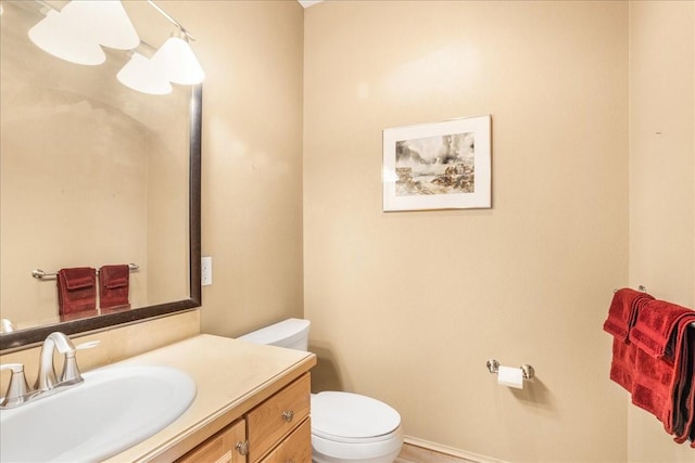 bathroom with toilet and vanity